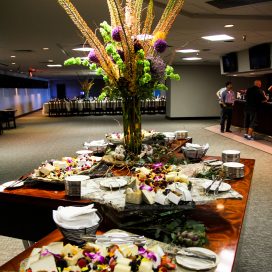 Large table of food and large flower arrangement