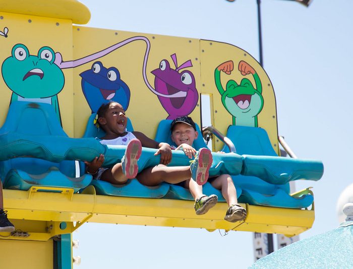 Two children on a carnival ride