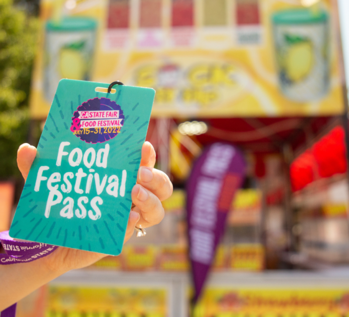 Hand holding the food festival pass
