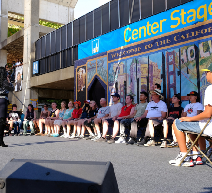 Hypnotist, Tina Marie, on PG&E Center Stage with a group of people sitting in a half circle in front of her