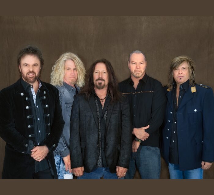38 Special standing in front of a brown backdrop