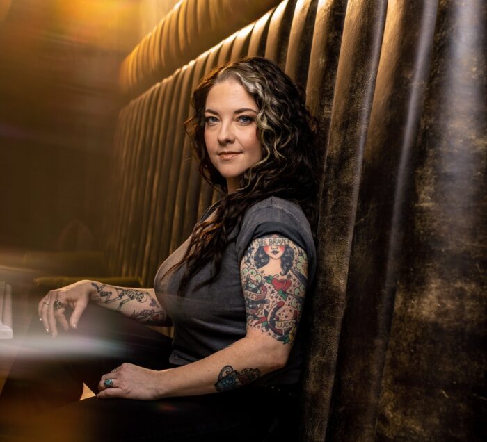 Ashley McBryde sitting in a booth