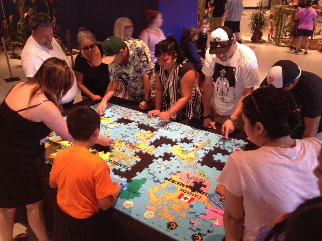 People putting together a large puzzle
