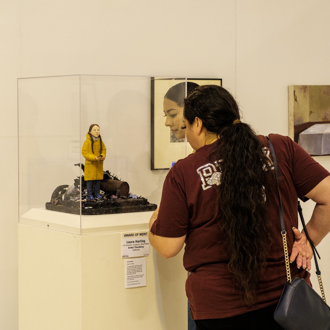 2 ladies looking at sculpture in a glass box