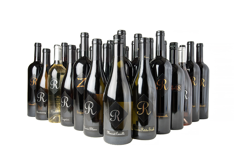 An assortment of wine bottles clustered together in a triangular shape isolated on a solid white background