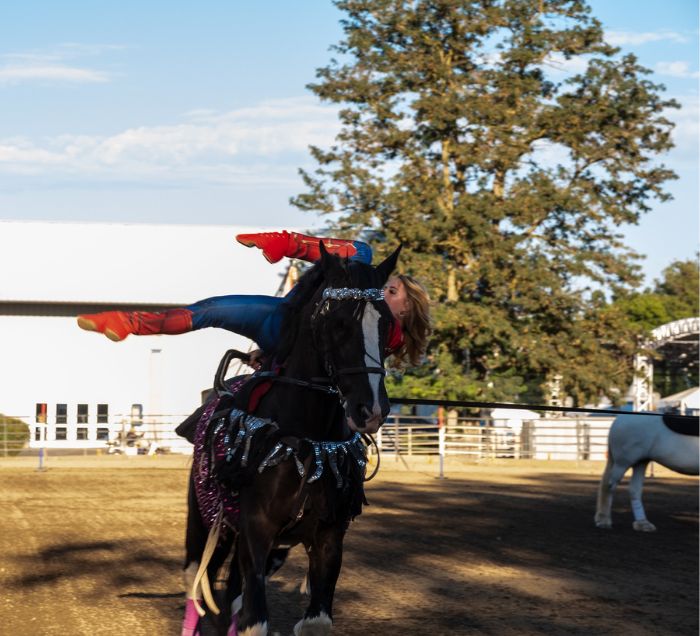 horse ride laying horizontally on a horse dressed in a wonder woman costume